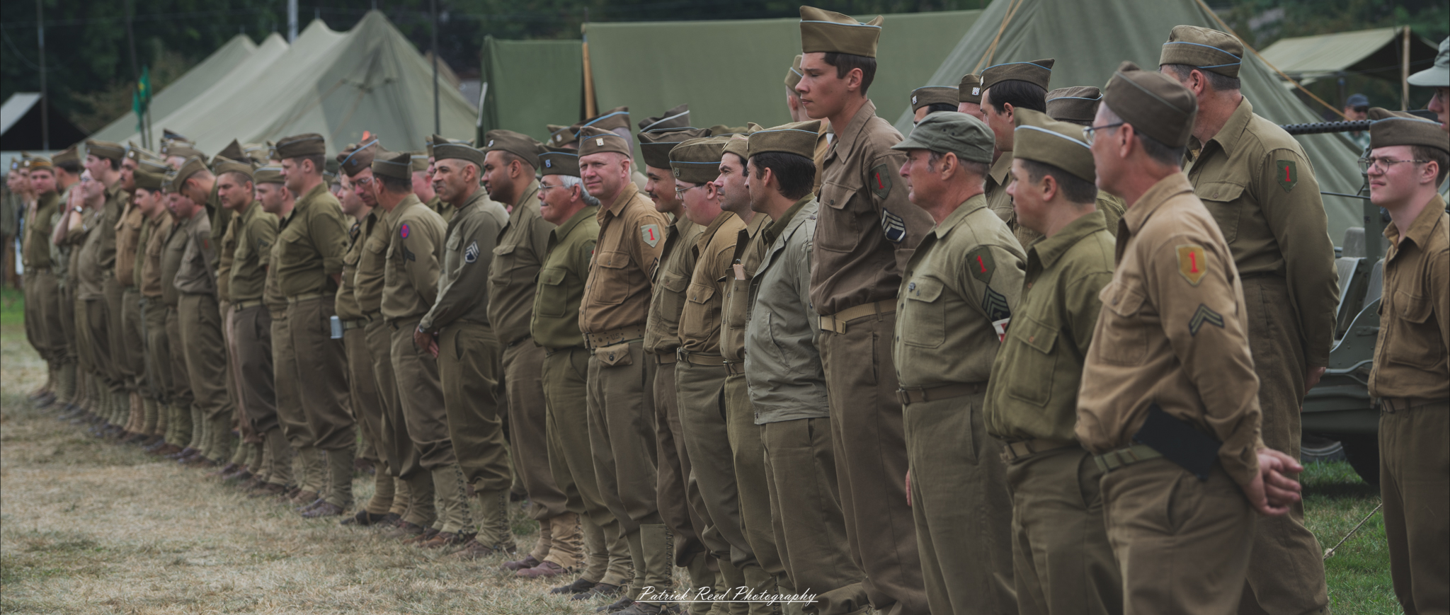 Soldiers standing in formation, perfectly aligned and attentive. The scene conveys a sense of discipline and unity, showcasing the precision and professionalism of military personnel during a parade or ceremonial event.